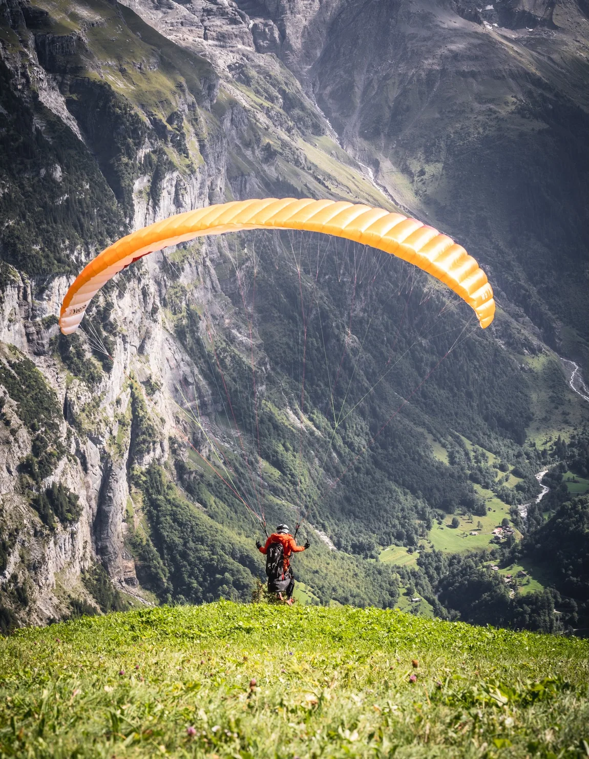 Paraglider over a dramatic mountain valley